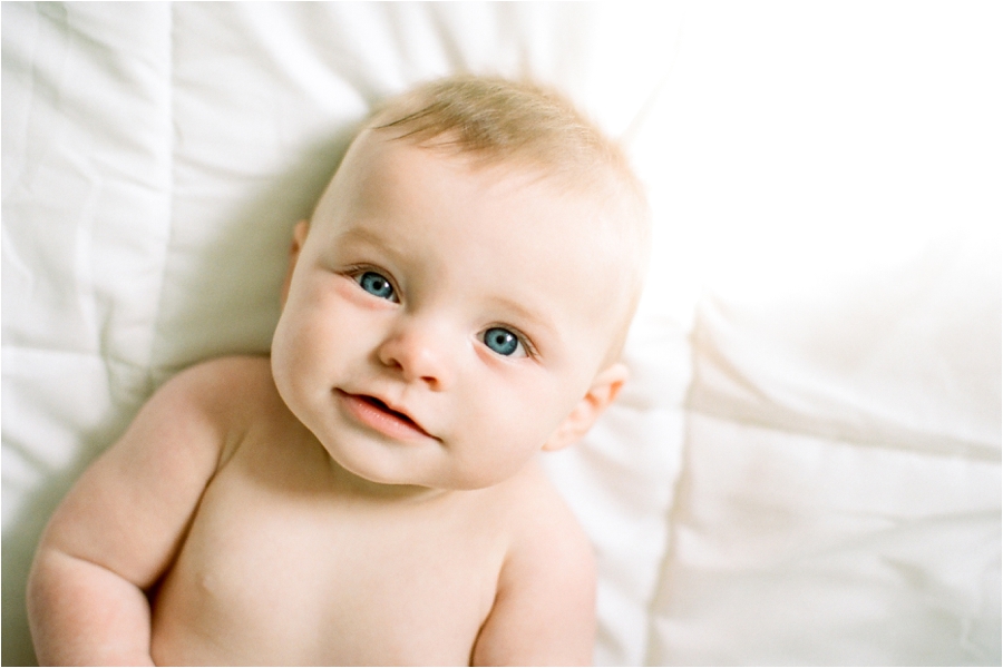 6 month old baby at home on bed