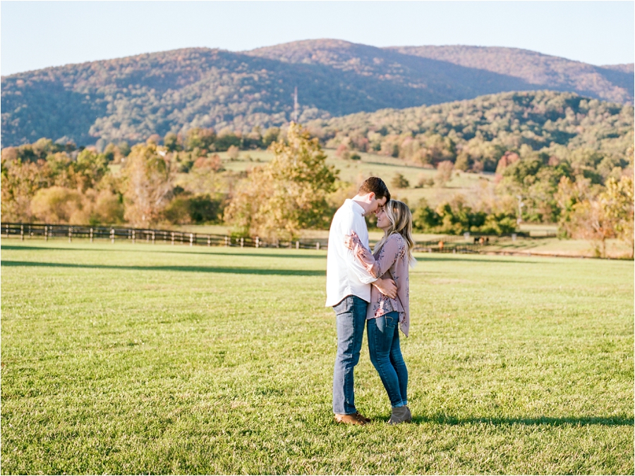 couple kissing in front of mountain range