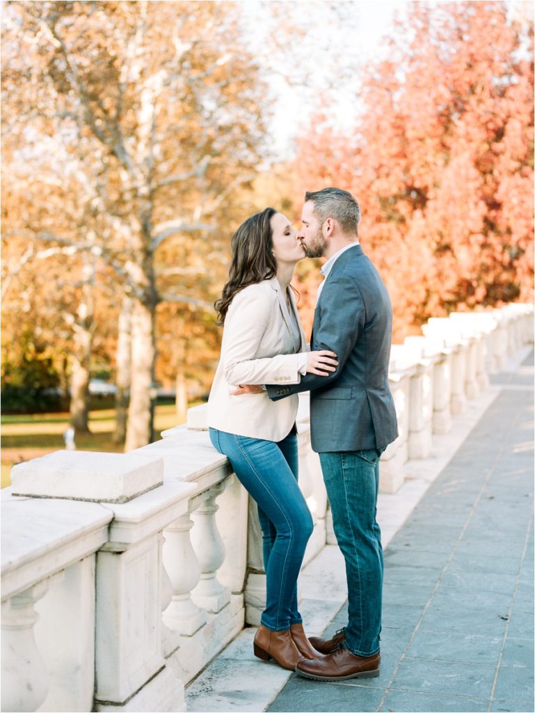 groom leaning in to kiss bride for engagement photos