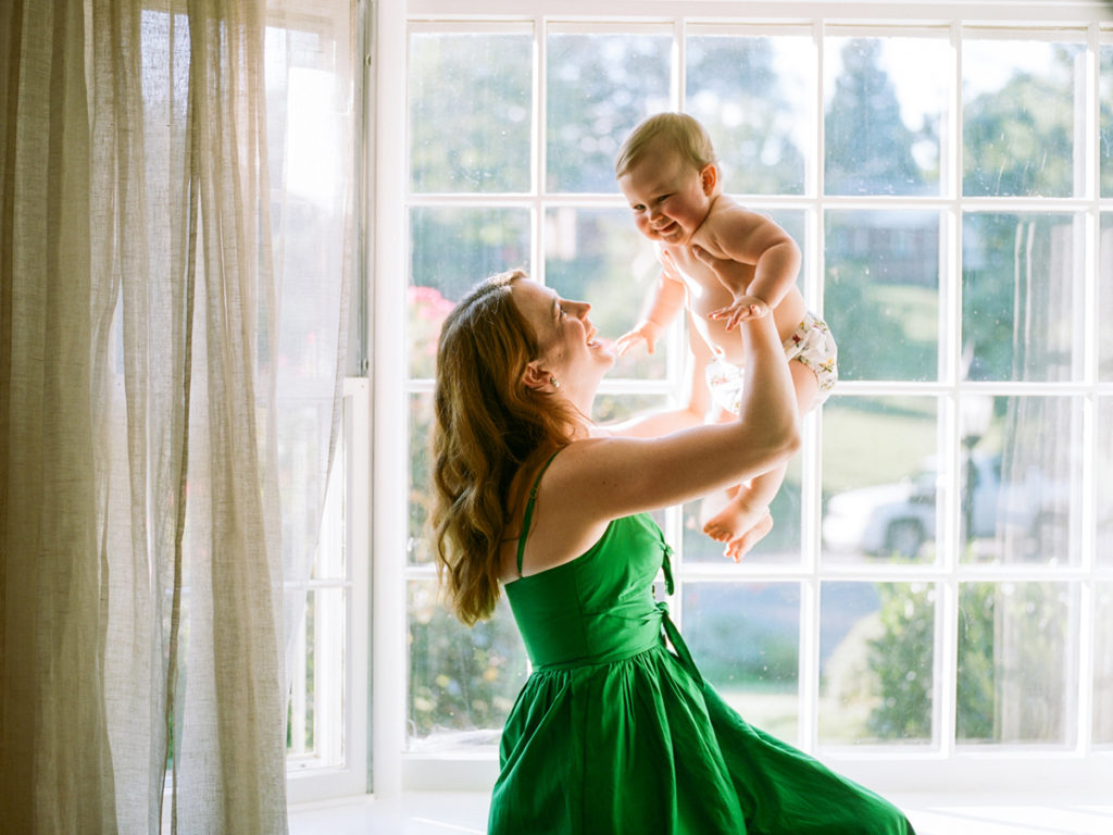 mom lifting baby in the air